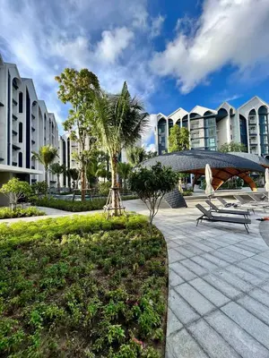 a park with benches and palm trees and buildings at MO607 1 br 36m in Nai Yang Beach