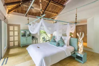 a bedroom with a white bed with a canopy at Paradise Koh Yao - Seaview Pool Villa in Ko Yao Noi