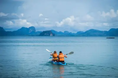 two people in a kayak in the water at Paradise Koh Yao - Seaview Pool Villa in Ko Yao Noi