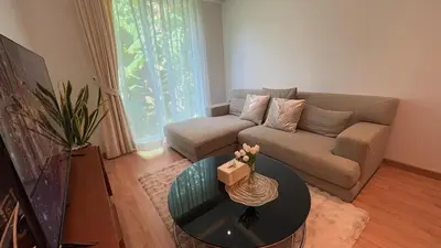 a living room with a couch and a table at The Privilege by Tris in Patong Beach