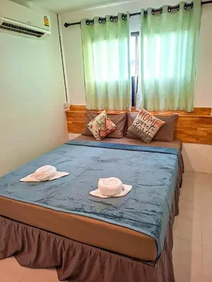 two hats on a bed in a room at MT Friend Hostel Phuket Town in Phuket Town