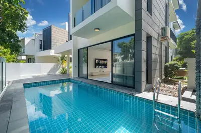 an external view of a house with a swimming pool at Luxury 5 bedroom villa Laguna Park in Laguna Phuket