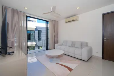 a living room with a couch and a tv at Luxury 5 bedroom villa Laguna Park in Laguna Phuket