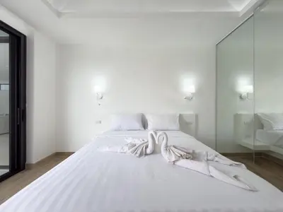 a white bed in a white room with a mirror at Stylish 3BR Pool Villa Lawan Villa (LWV1) in Phuket Town