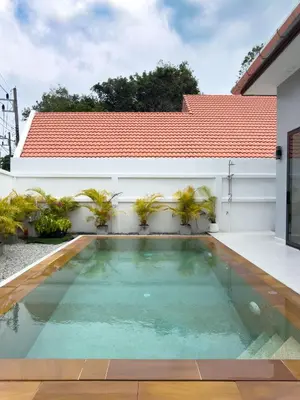 a swimming pool in the backyard of a house at Stylish 3BR Pool Villa Lawan Villa (LWV1) in Phuket Town