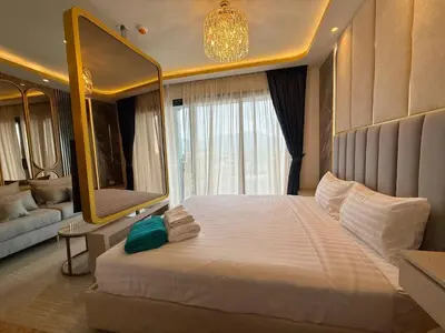 a bedroom with a large bed with a large mirror at Bangtao Studio Bellevue Lagoon 6floor pool view in Laguna Phuket