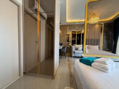 a bedroom with a bed with a large mirror at Bangtao Studio Bellevue Lagoon 6floor pool view in Laguna Phuket