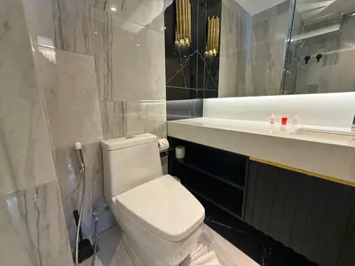 a bathroom with a toilet and a sink and a mirror at Bangtao Studio Bellevue Lagoon 6floor pool view in Laguna Phuket