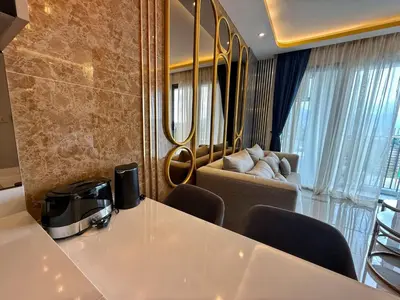 a living room with a table and a couch at Bangtao Studio Bellevue Lagoon 6floor pool view in Laguna Phuket