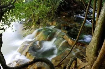 a stream of water rushing over rocks in a forest at Lanlay Home Stay Krabi in Ao Luk
