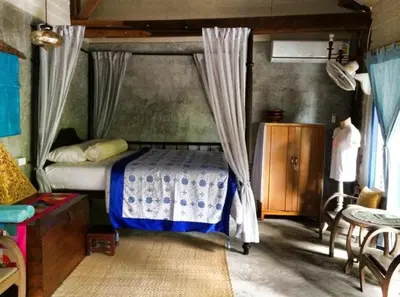 a bedroom with a bed with a canopy at Lanlay Home Stay Krabi in Ao Luk