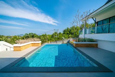 a swimming pool in the backyard of a house at Phu Talae Villa Rawai Beach in Ban Klang
