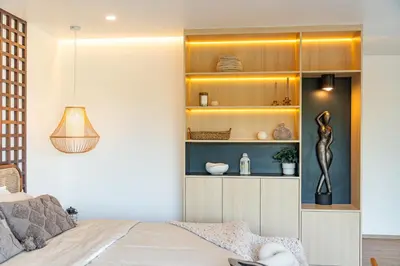 a bedroom with a bed and a shelf with vases at Phu Talae Villa Rawai Beach in Ban Klang