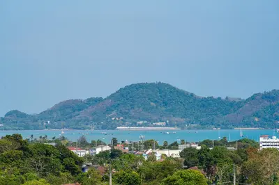 a view of a town and a river with mountains at Phu Talae Villa Rawai Beach in Ban Klang