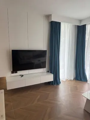 a living room with a flat screen tv on a white cabinet at Sunshine Beach, Kora Resort Phuket 5, Bang Tao, Laguna in Bang Tao Beach