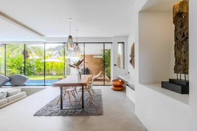 a dining room with a table and a couch at 2BR Modern Pool Villa Near the Sea V261 in Thalang