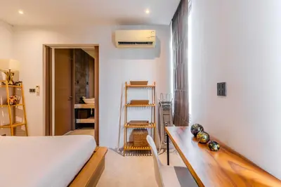 a bedroom with a bed and a wooden desk at 2BR Modern Pool Villa Near the Sea V261 in Thalang