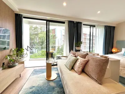 a living room with a couch and a bed at C243 1BR with Sofabed 5 Min Walk to Beach Pool&Gym in Thalang