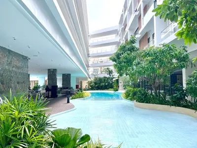 a swimming pool in the middle of a building at C243 1BR with Sofabed 5 Min Walk to Beach Pool&Gym in Thalang