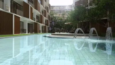 a swimming pool with water fountains in a building at C243 1BR with Sofabed 5 Min Walk to Beach Pool&Gym in Thalang
