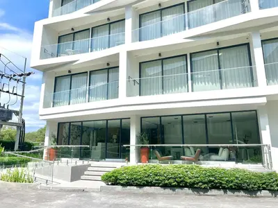 a large white building with glass windows at C243 1BR with Sofabed 5 Min Walk to Beach Pool&Gym in Thalang