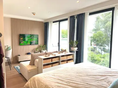 a bedroom with a bed and a living room at C243 1BR with Sofabed 5 Min Walk to Beach Pool&Gym in Thalang