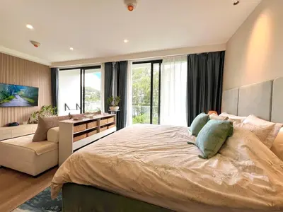 a bedroom with a large bed and a desk at C243 1BR with Sofabed 5 Min Walk to Beach Pool&Gym in Thalang