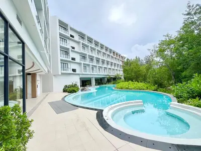 an external view of a building with a swimming pool at C243 1BR with Sofabed 5 Min Walk to Beach Pool&Gym in Thalang