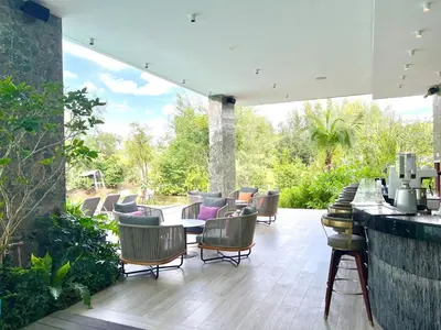 a patio with a bunch of chairs and a bar at C243 1BR with Sofabed 5 Min Walk to Beach Pool&Gym in Thalang