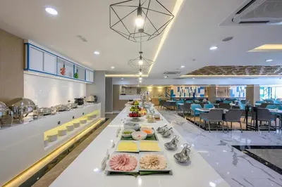 a long table with food on it in a restaurant at C244 Ocean Breeze 1BR Studio Steps from the Sea in Ban Saiyuan (1)