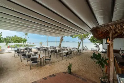 a group of tables and chairs on the beach at C245 Steps from the Beach Pool & Ocean View in Ban Saiyuan (1)