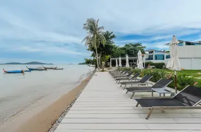a row of chairs and umbrellas on the beach at C245 Steps from the Beach Pool & Ocean View in Ban Saiyuan (1)