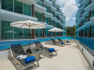 a group of chairs and umbrellas next to a pool at C245 Steps from the Beach Pool & Ocean View in Ban Saiyuan (1)