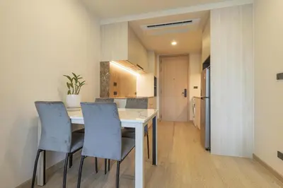 a kitchen and dining room with a table and chairs at C247 Brand-New Condo with Pool, Gym & Beach Nearby in Thalang