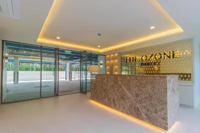a lobby with a stone counter in a building at C247 Brand-New Condo with Pool, Gym & Beach Nearby in Thalang