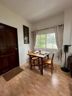 a dining room with a table and chairs and a window at Floresh Freedom Hostel in Phuket