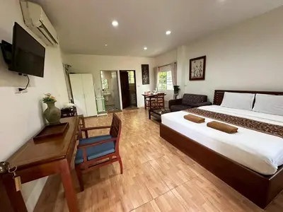a hotel room with a bed and a desk and a room at Floresh Freedom Hostel in Phuket