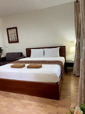 a bedroom with a large bed with two pillows on it at Floresh Freedom Hostel in Phuket
