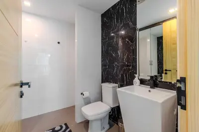 a bathroom with a white toilet and a sink at C248 Condo 3 Min to Nai Harn Beach 1BR with Rooftop Pool in Rawai Beach