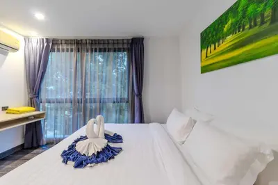 a bedroom with a swan decoration on a bed at C248 Condo 3 Min to Nai Harn Beach 1BR with Rooftop Pool in Rawai Beach