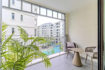a balcony with a table and chairs and a large window at C249 Brand new Pool view stay with great amenity in Bang Tao Beach