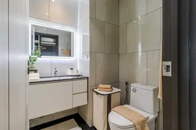a white bathroom with a toilet and a sink at C250 Brand new Stay near top beach & Boat Avenue in Thalang