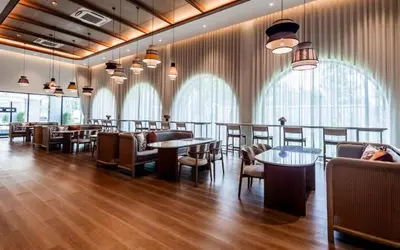 a restaurant with tables and chairs and windows at C250 Brand new Stay near top beach & Boat Avenue in Thalang