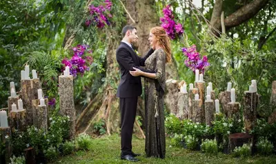 a man and woman standing in front of a cemetery at Keemala - Clay Pool Cottage in Kamala Beach