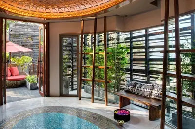 a pool in a room with a table and a bench at Keemala - Clay Pool Cottage in Kamala Beach