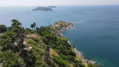 an island with palm trees and the ocean at Amaleena Pool Access Suites in Ban Bang Chak