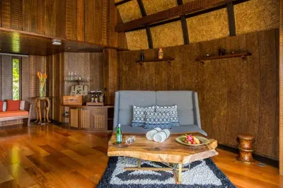 a living room with a couch and a table at Keemala - Birds Nest Pool Villa in Kamala Beach