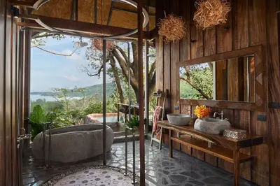 a bathroom with a tub and a sink and a mirror at Keemala - Birds Nest Pool Villa in Kamala Beach