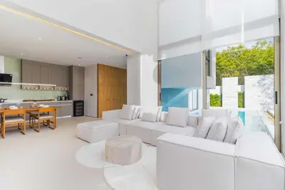 a living room with white furniture and a kitchen at V271 Smart Villa Full Amenities Best Stay Escape in Thalang