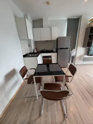 a kitchen with a table and chairs in a room at The closest accommodation next too central Mall in Ban Rangeng